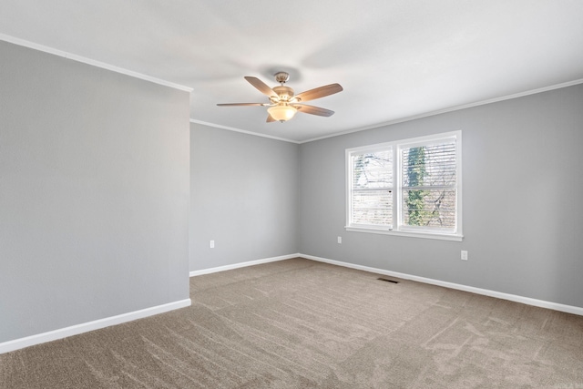 unfurnished room featuring visible vents, carpet flooring, ceiling fan, and crown molding