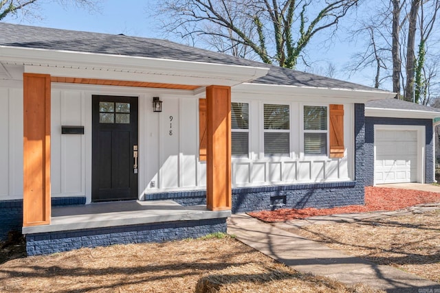 entrance to property with covered porch and roof with shingles