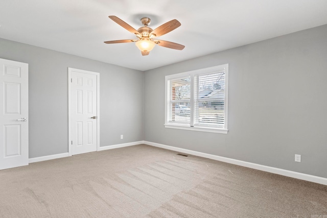 unfurnished room featuring visible vents, baseboards, ceiling fan, and carpet floors