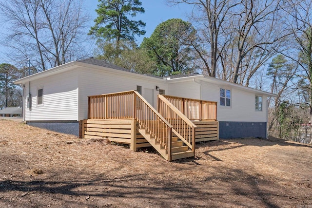 back of property featuring crawl space, a deck, and stairs