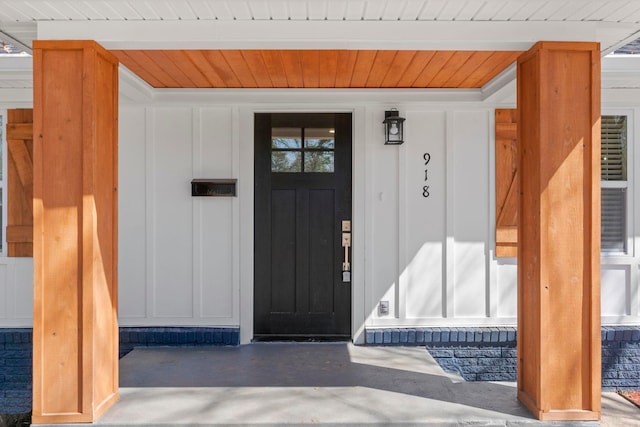 property entrance featuring board and batten siding