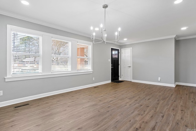 interior space with a chandelier, visible vents, a healthy amount of sunlight, and crown molding