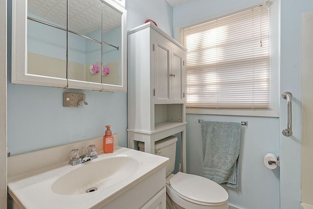 bathroom featuring toilet and vanity