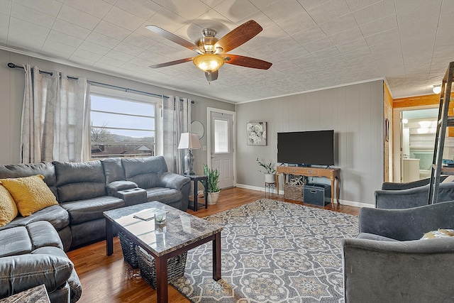 living room featuring ceiling fan, wood finished floors, and ornamental molding