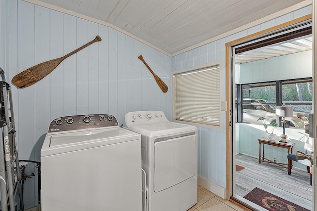 laundry room with light tile patterned floors, laundry area, and washing machine and clothes dryer