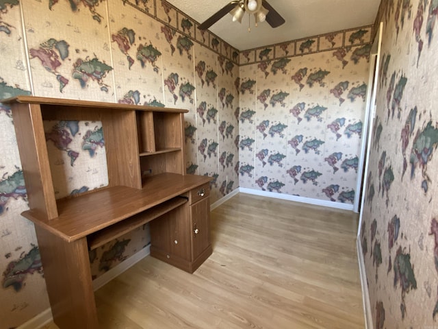 home office featuring baseboards, light wood-style floors, a ceiling fan, and wallpapered walls