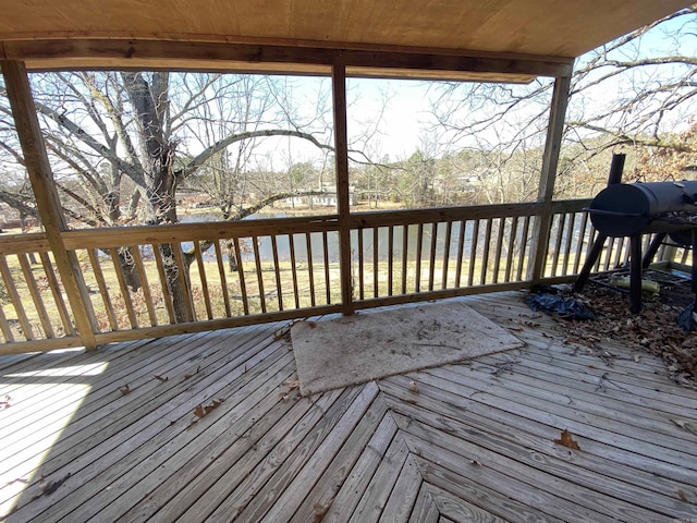 wooden deck featuring a grill