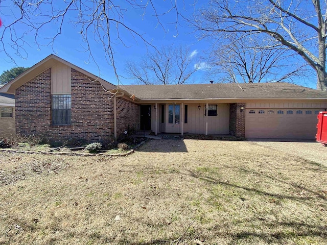 single story home with brick siding and an attached garage