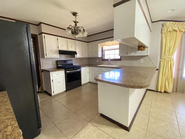 kitchen with under cabinet range hood, range with gas cooktop, a peninsula, and white cabinets