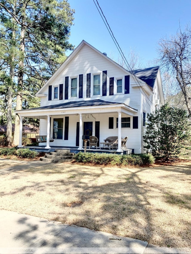 view of front of house with a porch and a front lawn