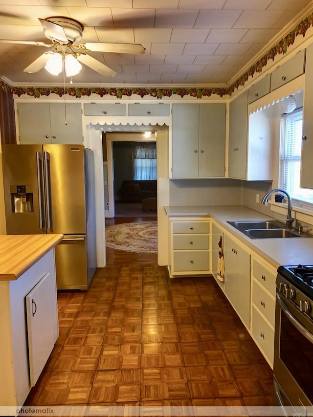 kitchen featuring ceiling fan, appliances with stainless steel finishes, and a sink