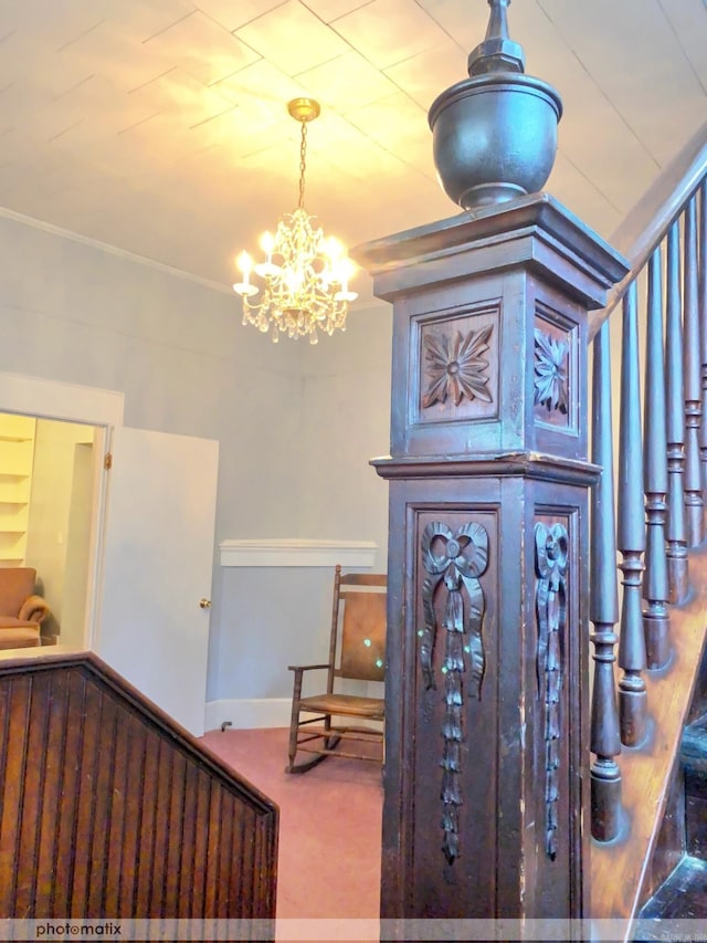 staircase with a notable chandelier, baseboards, and carpet floors