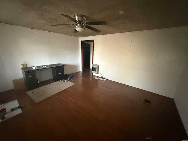 unfurnished living room with heating unit and ceiling fan