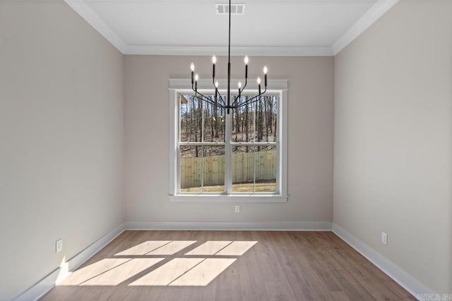 unfurnished dining area featuring a chandelier, visible vents, a healthy amount of sunlight, and wood finished floors