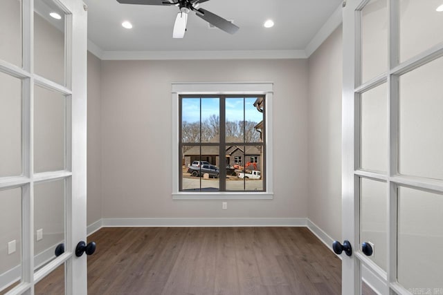 empty room with crown molding, baseboards, recessed lighting, wood finished floors, and a ceiling fan