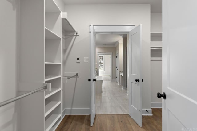 spacious closet with wood finished floors