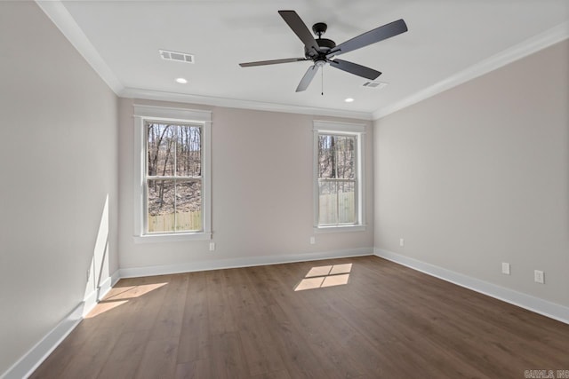 empty room featuring visible vents, baseboards, ornamental molding, and dark wood-style flooring