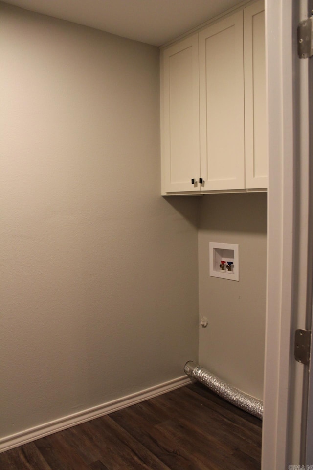 laundry area featuring washer hookup, cabinet space, dark wood-style flooring, and baseboards