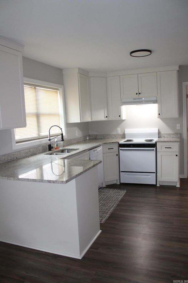 kitchen with white appliances, white cabinets, under cabinet range hood, and a sink