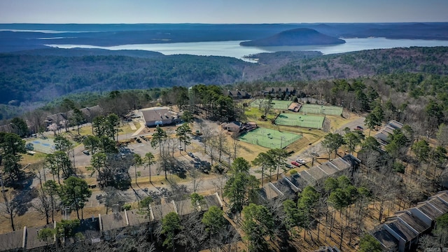 birds eye view of property featuring a wooded view and a water view