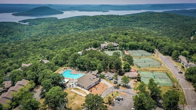 bird's eye view featuring a wooded view and a water view