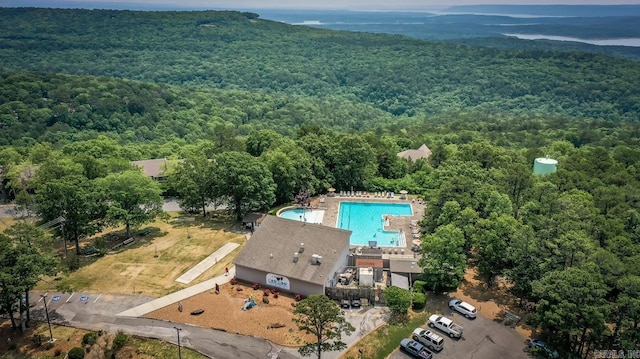 birds eye view of property featuring a view of trees