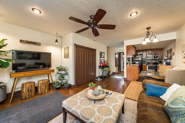 living room with dark wood-style floors, a textured ceiling, and ceiling fan