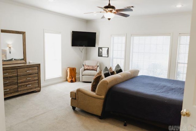 carpeted bedroom with a ceiling fan and ornamental molding