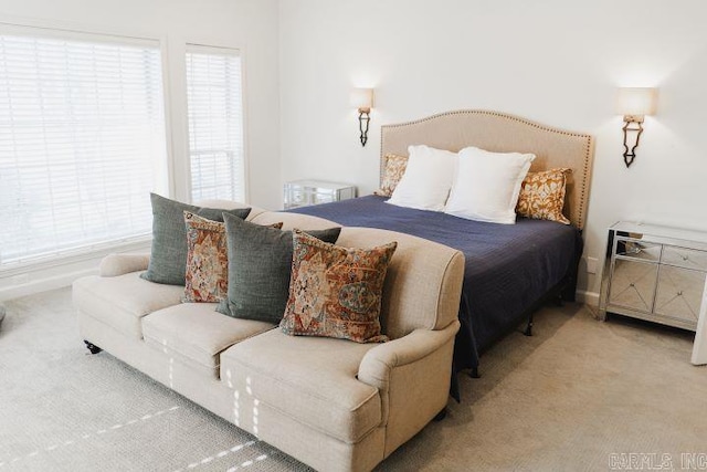 carpeted bedroom featuring baseboards