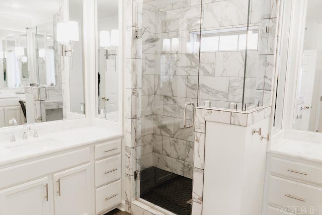 full bathroom with a sink, two vanities, and a stall shower