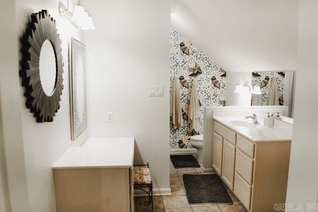 bathroom featuring tile patterned floors, toilet, vanity, and vaulted ceiling