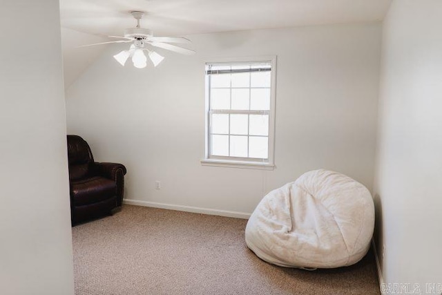 living area featuring carpet flooring, a ceiling fan, and baseboards