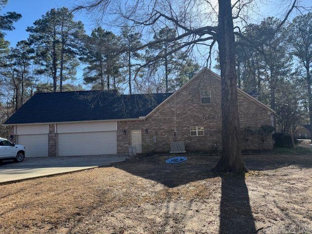 view of home's exterior with concrete driveway and a garage