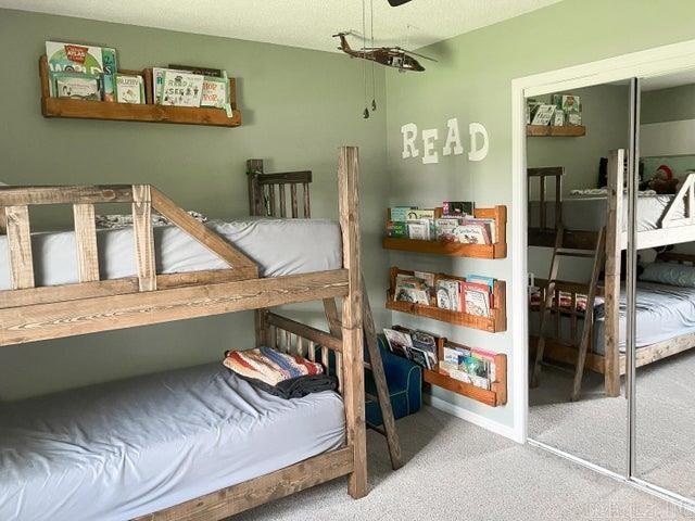 carpeted bedroom featuring a closet