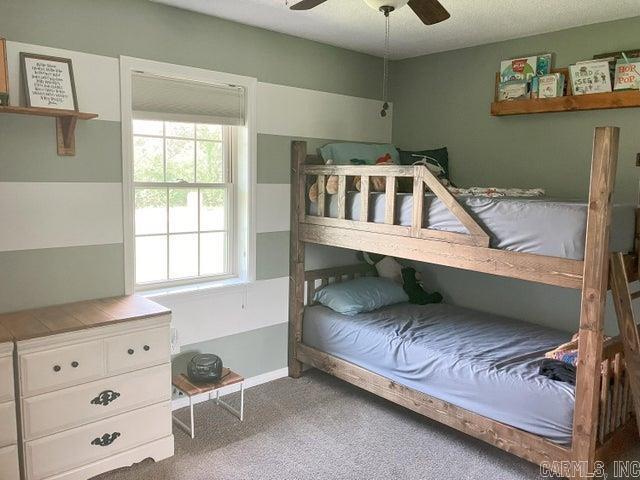 bedroom with a ceiling fan and carpet flooring