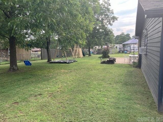 view of yard with cooling unit and fence