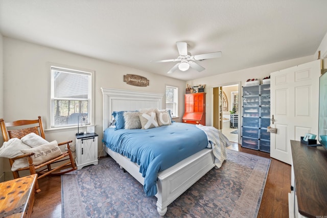 bedroom featuring dark wood finished floors, multiple windows, and a ceiling fan