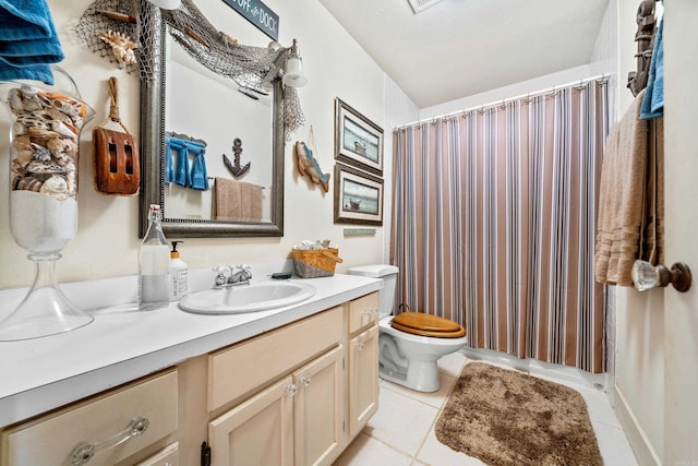 bathroom with tile patterned floors, toilet, vanity, and a textured ceiling