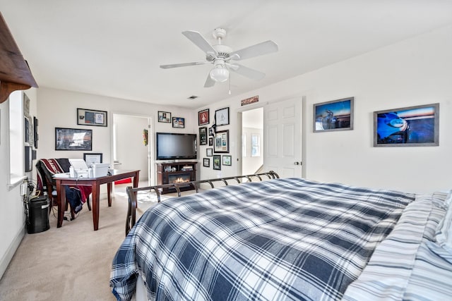 bedroom featuring baseboards, light carpet, and a ceiling fan