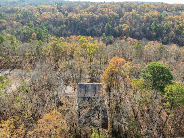 birds eye view of property featuring a view of trees