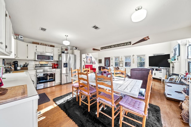 dining room with visible vents and light wood finished floors