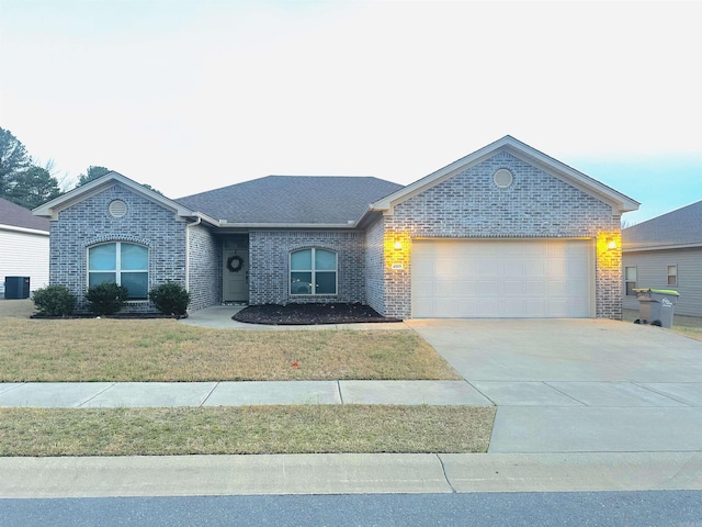 ranch-style house with brick siding, an attached garage, driveway, and a front yard