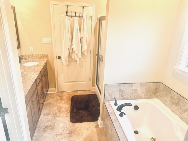 full bathroom with a stall shower, a bath, and vanity