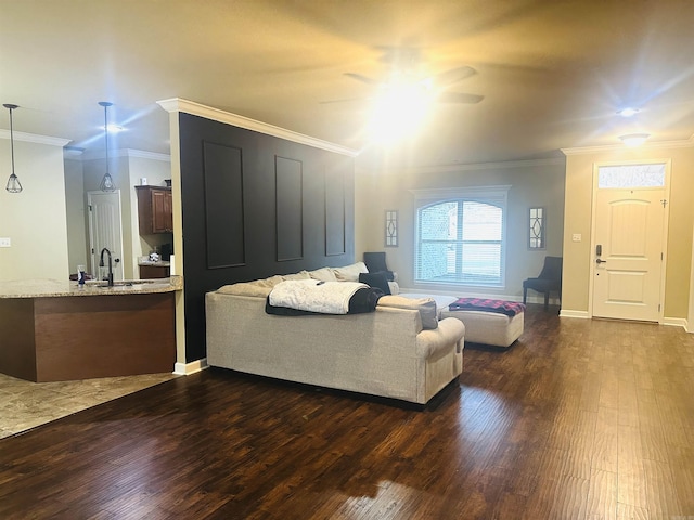 living room featuring baseboards, crown molding, ceiling fan, and dark wood-style flooring