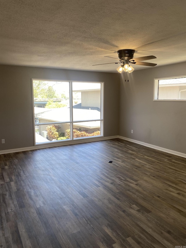 unfurnished room with a textured ceiling, ceiling fan, and dark wood finished floors