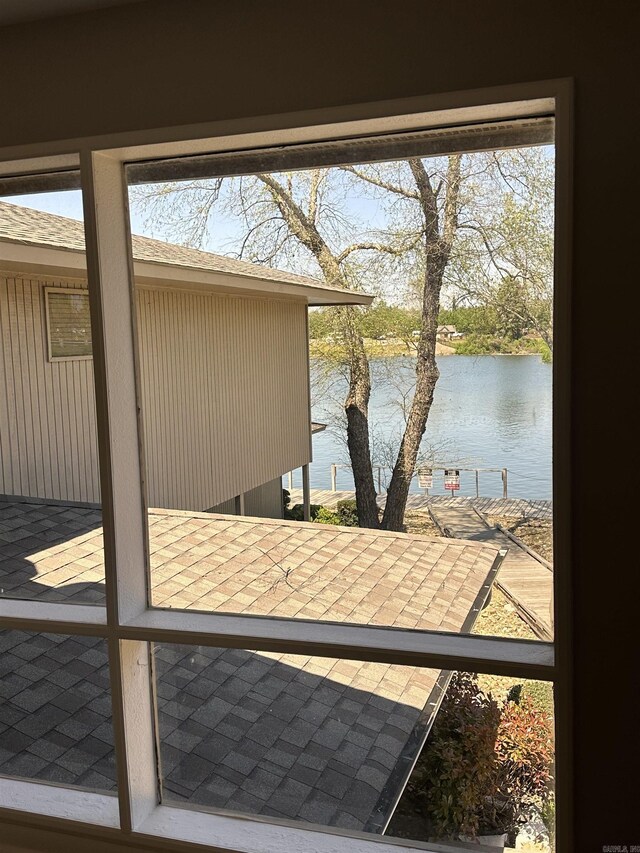 doorway with a water view and a healthy amount of sunlight