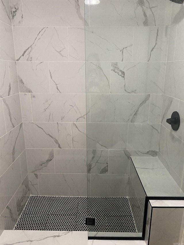 bathroom with tiled shower