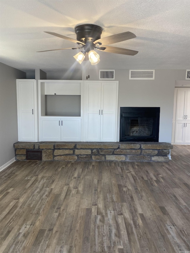 unfurnished living room featuring visible vents, wood finished floors, and ceiling fan