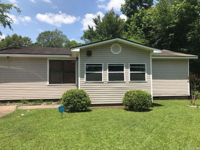 back of house with a yard and crawl space