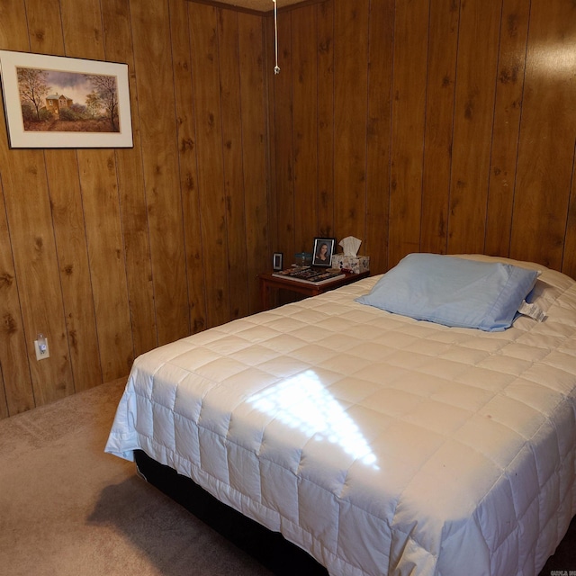 bedroom featuring wooden walls and carpet flooring